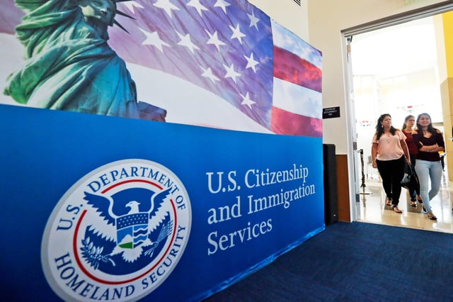 FILE - People arrive at the U.S. Citizenship and Immigration Services in Miami, Aug. 17, 2018. (AP Photo/Wilfredo Lee, File)