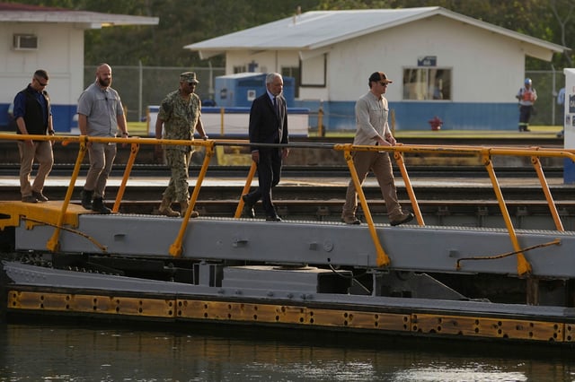 US Secretary of Defense Pete Hegseth, right, and Panama Canal Authority Administrator Ricaurte Vasquez, second from right, cross a bridge during a tour of the Panama Canal's Miraflores Locks in Panama City on Tuesday.
