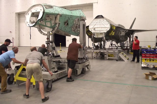 Personnel at Hill Air Force Base, Utah, reposition a salvaged nose section from an F-35 airframe using a new Mobil Maintenance System in October 2023.