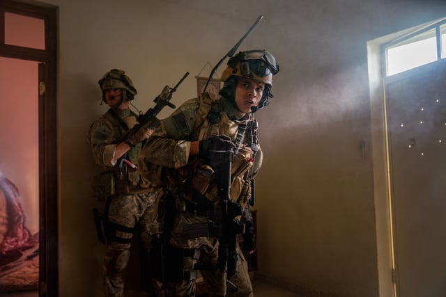 D'Pharaoh Woon-A-Tai (right) plays a communication officer and Will Poulter is the leader of a Navy SEAL team under fire in the movie "Warfare."