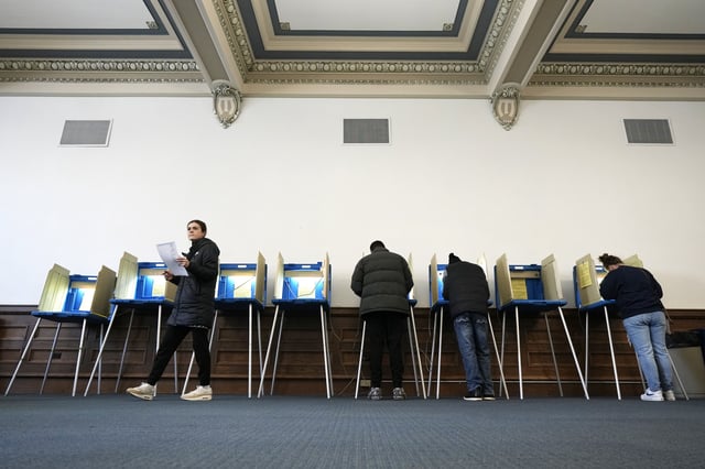 Voters mark their ballots while voting at Centennial Hall at the Milwaukee Central Library on Election Day Tuesday, April 1, 2025, in Milwaukee. (AP Photo/Kayla Wolf)