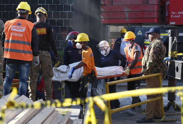 Rescue workers recover the body of a victim who died in Tuesday's tragedy.