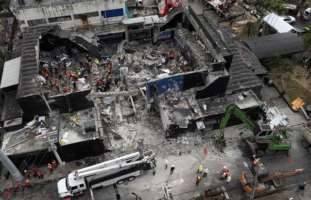 Rescue teams work at the Jet Set nightclub on Wednesday, a day after its roof collapsed killing at least 184 people in an incident that sent shockwaves around the country.