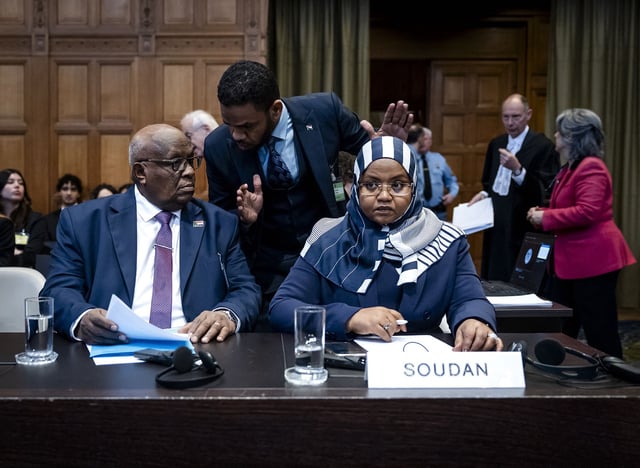 Muawia Osman Mohamed Khair (L), Sudan's acting Minister of Justice, and Sudanese ambassador to the Netherlands Omaima Alsharief wait for the start of a hearing before the International Court of Justice in The Hague, on Thursday.