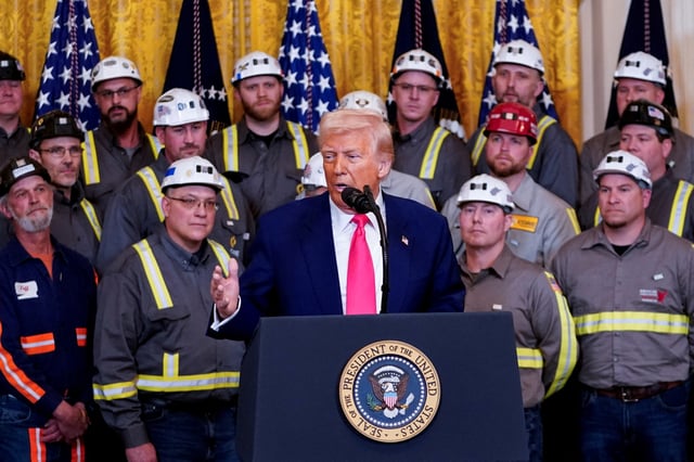 U.S. President Donald Trump speaks next to coal industry workers, on the day he signs energy-related executive orders at the White House in Washington, D.C., U.S., April 8, 2025. REUTERS/Nathan Howard/File Photo