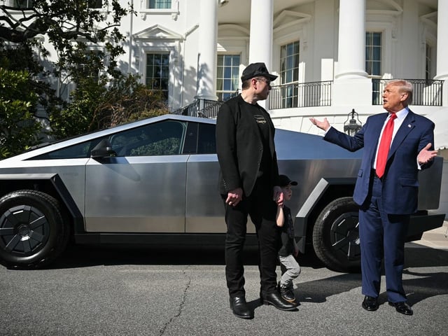 Trump and Musk stand next to a Cybertruck in front of the White House on Tuesday.