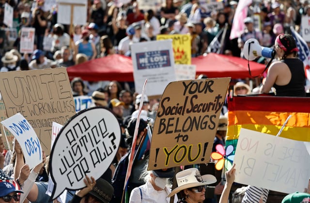 A person holds a sign reading 'Your Social Security Belongs to You!' as protestors prepare to march in a protest against the Trump administration on April 5, 2025, in Los Angeles, California.