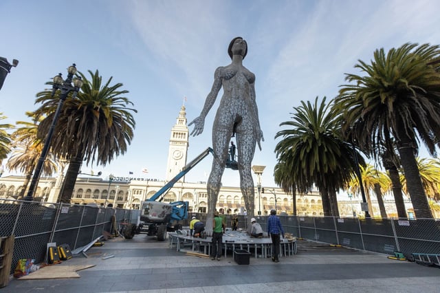 Workers install the R-Evolution statue at Embarcadero Plaza in San Francisco on April 9, 2025, in advance of its public unveiling on April 10.