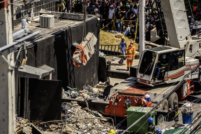 Personnel from civil defense and firefighters work at the Jet Set nightclub following the collapse of its roof in Santo Domingo on April 8, 2025.