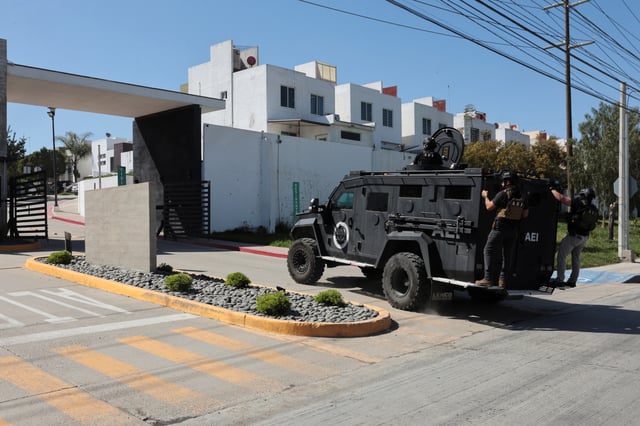 Members of security forces work near a crime scene where a U.S. citizen shot and killed Abigail Esparza Reyes, 33, a top Mexican state police officer in an elite unit known as the "Gringo Hunters", which tracks and arrests U.S. fugitives in Mexico, in Tijuana, Mexico, April 9, 2025. REUTERS/Stringer