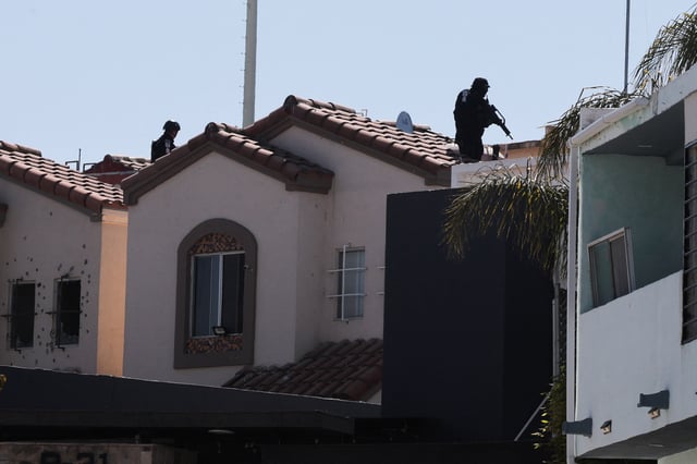 Members of security forces work near a crime scene where a U.S. citizen shot and killed Abigail Esparza Reyes, 33, a top Mexican state police officer in an elite unit known as the "Gringo Hunters", which tracks and arrests U.S. fugitives in Mexico, in Tijuana, Mexico, April 9, 2025. REUTERS/Stringer