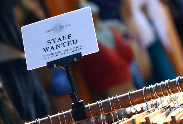 A clothing retail shop advertises for workers in Brighton, Britain, August 15, 2023. REUTERS/Toby Melville/File Photo