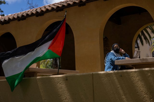 A student attends an event at a protest encampment in support of Palestinians at Stanford University during the ongoing conflict between Israel and the Palestinian Islamist group Hamas, in Stanford, California U.S., April 26, 2024. REUTERS/Carlos Barria/File Photo