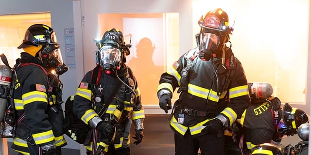 Bobby Nash, Chimney Han, and Hen Wilson tending to a lab fire in their gear in 9-1-1 Season 8