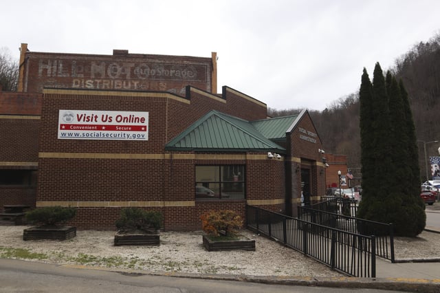 A sign outside the U.S. Social Security Administration advertises its online services in downtown Welch, W.Va., Thursday, March 20, 2025. (AP Photo/Leah Willingham)