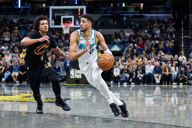 Apr 10, 2025; Indianapolis, Indiana, USA; Indiana Pacers guard Tyrese Haliburton (0) dribbles the ball while Cleveland Cavaliers guard Craig Porter Jr. (9) defends in the second half at Gainbridge Fieldhouse. Mandatory Credit: Trevor Ruszkowski-Imagn Images