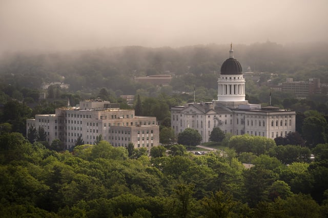 FILE-The morning fog lifts beyond the Burton M. Cross Building, left, and the State House, in this June 21, 2023, file photo, in Augusta, Maine. (AP Photo/Robert F. Bukaty, File)