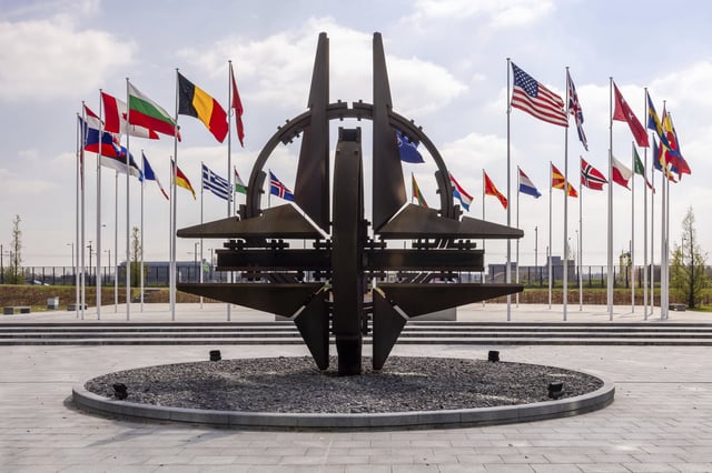 Flags of the Alliance members flap in the wind prior to a coalition of the willing defence ministers meeting at NATO headquarters in Brussels, Belgium, Thursday, April 10, 2025. (AP Photo/Geert Vanden Wijngaert)