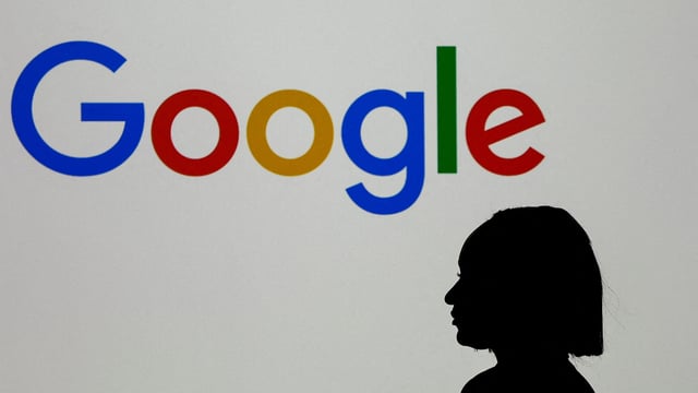 A woman stands in front of a Google logo during a media reception at the Google France headquarters ahead of the Artificial Intelligence Action Summit in Paris, France, February 9, 2025.
