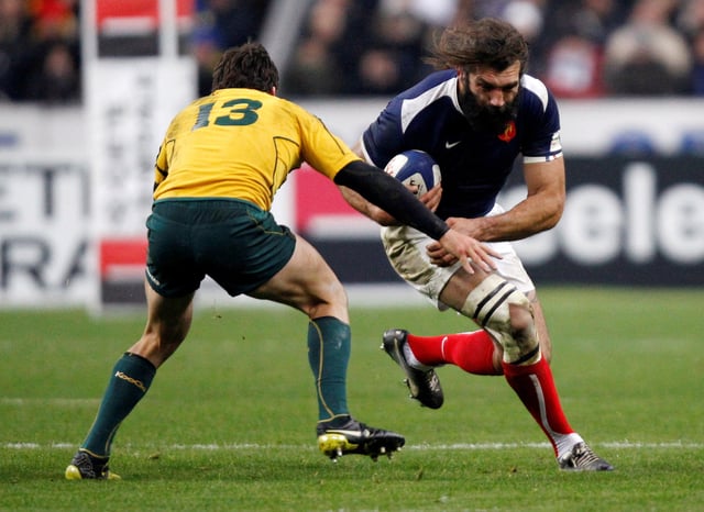 France's Sebastien Chabal (R) challenges Australia's Adam Ashley-Cooper during their friendly international rugby union test match at the Stade de France stadium in Saint Denis, near Paris November 27, 2010.    REUTERS/John Schults/File Photo