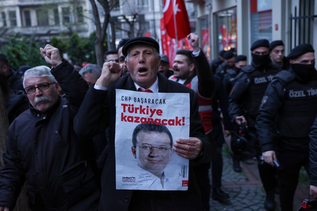 A man holds a poster with a picture of Istanbul Mayor Ekrem Imamoglu during a rally to protest against the arrest of Imamoglu as part of a corruption investigation, in Istanbul, Turkey, April 9, 2025. REUTERS/Dilara Senkaya/File Photo