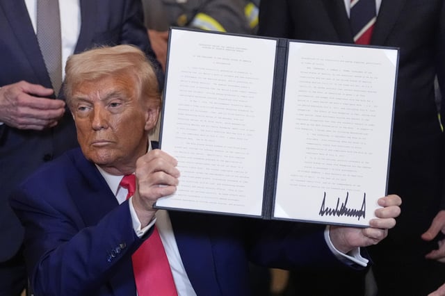 President Donald Trump holds a signed an executive order during an event in the East Room of the White House, Tuesday, April 8, 2025, in Washington.