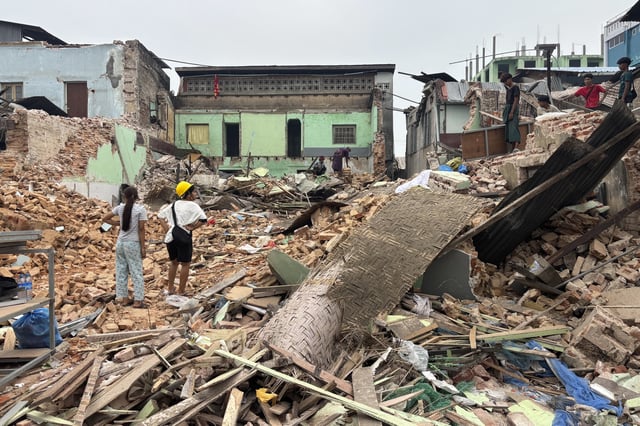 People clean debris from damaged buildings in the aftermath of an earthquake on March 28, in Naypyitaw, Myanmar, Monday, April 7, 2025. (AP Photo)