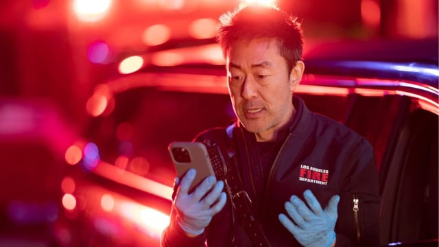 Chimey looks at his phone in 9-1-1