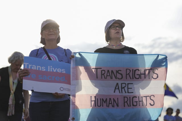People attend the &#39;Trans Day of Visibility Rally&#39; hosted by the Christopher Street Project on the National Mall in Washington, D.C. on March 31, 2025.