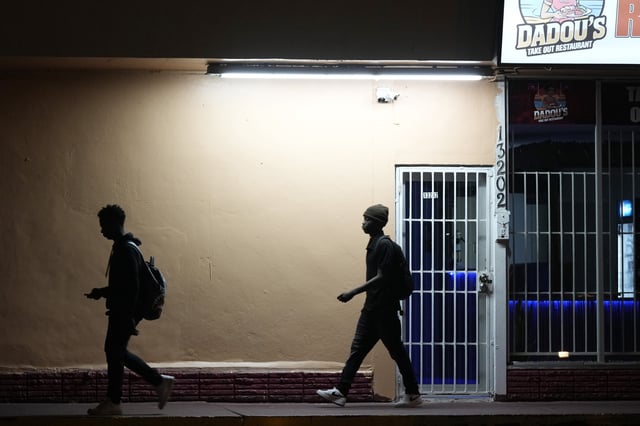FILE - High school students walk in the dark to school, Oct. 29, 2024, in North Miami, Fla. (AP Photo/Marta Lavandier, File)
