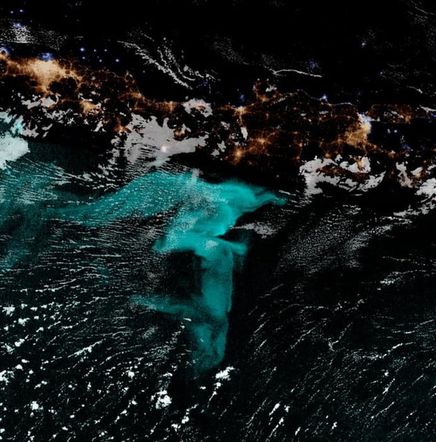 For centuries, sailors have told tales of milky seas – huge swaths of ocean glowing on dark nights, seen in blue in this false–color satellite image. Steven D. Miller/NOAA (Credit: Colorado State University/NOAA)