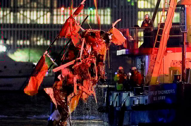 Emergency personnel work at the scene of a helicopter crash on the Hudson River near lower Manhattan in New York, as seen from Newport, New Jersey U.S., April 10, 2025.  REUTERS/Eduardo Munoz