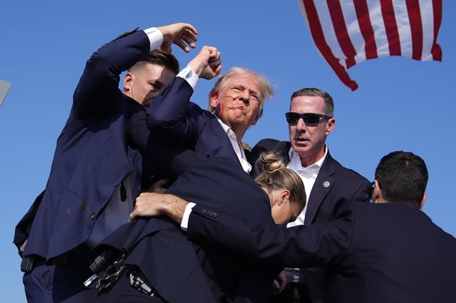 FILE - Republican presidential candidate former President Donald Trump is surrounded by U.S. Secret Service agents at a campaign rally, July 13, 2024, in Butler, Pa. (AP Photo/Evan Vucci, File)