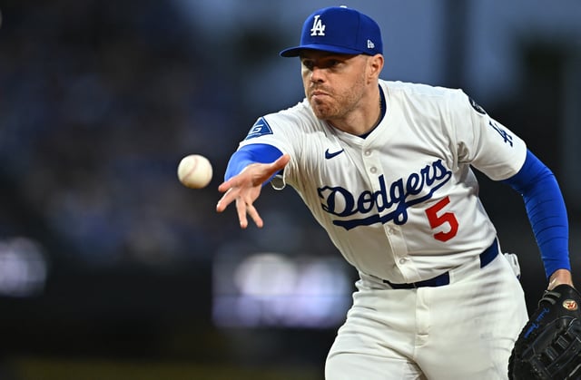 Mar 29, 2025; Los Angeles, California, USA; Los Angeles Dodgers first baseman Freddie Freeman (5) tosses to first for an out during the 3rd inning against the Detroit Tigers at Dodger Stadium. Mandatory Credit: Jonathan Hui-Imagn Images/File Photo