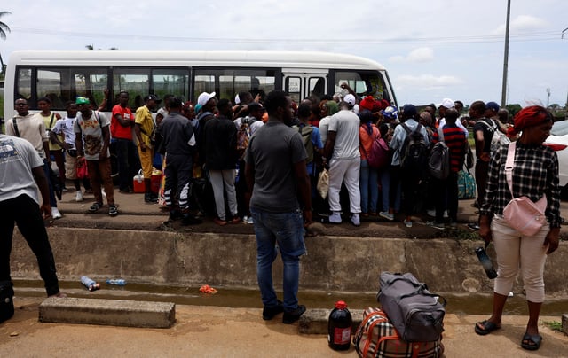 People prepare to take a bus to vote in the towns where they have registered, a day ahead of the 2025 Gabonese presidential election in Libreville, Gabon, April 11, 2025. REUTERS/Luc Gnago
