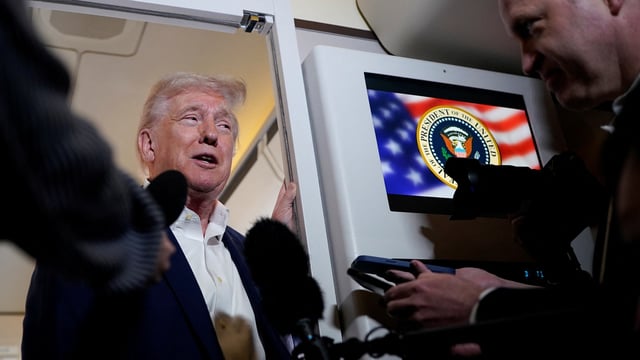U.S. President Donald Trump talks to the media on board Air Force One on the way to Palm Beach International Airport