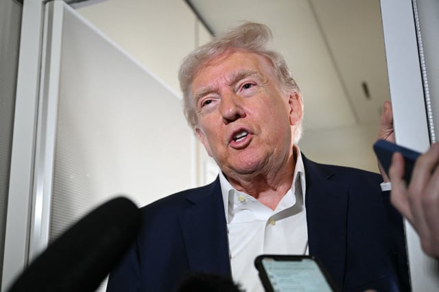 President Donald Trump can be seen speaking to reporters while in flight on Air Force One, en route to Palm Beach International Airport in West Palm Beach, Florida, on April 11, 2025. (Photo by MANDEL NGAN / AFP) (Photo by MANDEL NGAN/AFP via Getty Images)