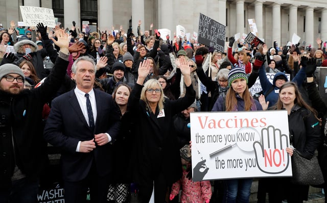 In this February 2019 photo, Robert F. Kennedy, Jr. stands with protesters at the Capitol in Olympia, Washington, where they opposed a bill to tighten measles, mumps and rubella vaccine requirements for school-aged children.