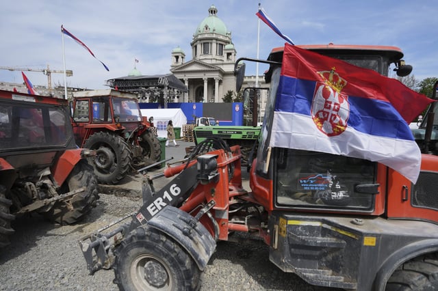 Tractors are parked in front of Serbian parliament building ahead of a big counter-opposition protest rally planned to stage over the weekend in downtown Belgrade, Serbia, Friday, April 11, 2025. (AP Photo/Darko Vojinovic)