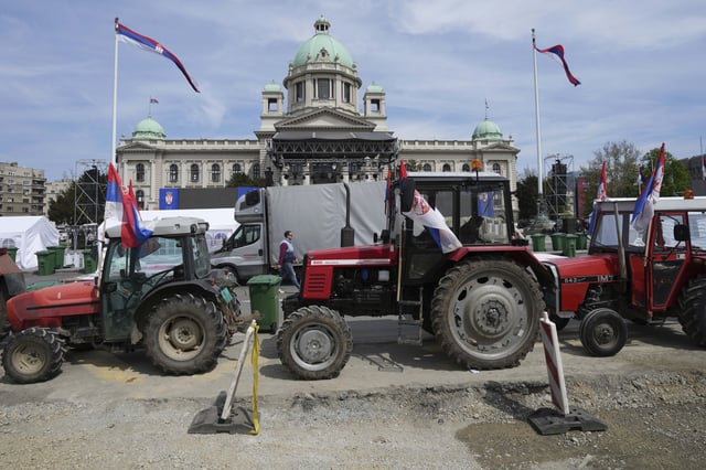 Tractors are parked in front of the Serbian parliament building ahead of a big counter-opposition protest rally planned to be staged over the weekend in downtown Belgrade, Serbia, Friday, April 11, 2025. (AP Photo/Darko Vojinovic)