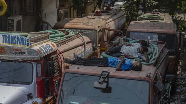 Mumbai, India - April 10, 2025: Workers rest atop a water tanker during an indefinite strike called by the Mumbai Water Tanker Association (MWTA), protesting civic body notices to private ring well and borewell owners. The strike has prompted Maharashtra politicians to seek intervention from the Centre in Mumbai, India, on Thursday, April 10, 2025. (Photo by Satish Bate/ Hindustan Times) (Hindustan Times)