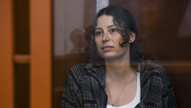 Ksenia Karelina, also known as Khavana sits in a glass cage in a court room in Yekaterinburg, Russia, Thursday, June 20, 2024.