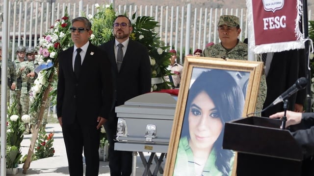 Colleagues, friends and family say goodbye to  Baja California police Cmdr. Abigail Esparza Reyes, pictured at right, on Friday at the Tijuana Control and Command Center, known as C5. (Baja California Government Press Office)