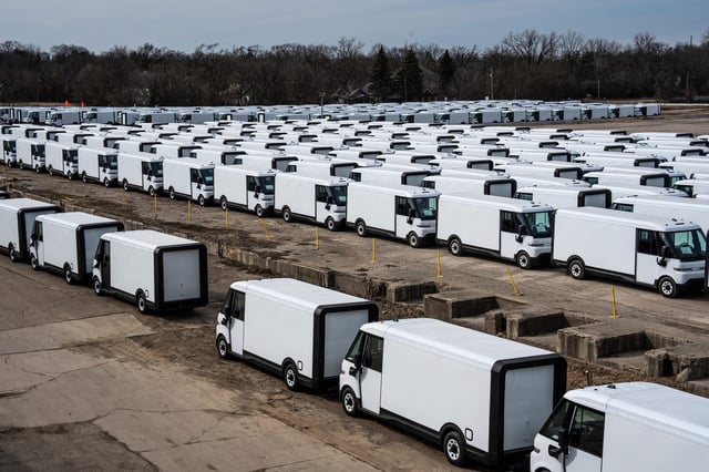 A smaller section of BrightDrop EV delivery vans are stored in rows in a lot in Flint on Wednesday, March 12, 2025.