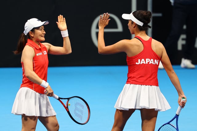 Tennis - Billie Jean King Cup Qualifiers - Group A - Canada v Japan - Ariake Colosseum, Tokyo, Japan - April 13, 2025 Japan's Ena Shibahara and Shuko Aoyama react during their doubles match against Canada's Rebecca Marino and Kayla Cross REUTERS/Kim Kyung-Hoon