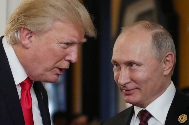 US President Donald Trump (L) chats with Russia&#39;s President Vladimir Putin as they attend the APEC Economic Leaders&#39; Meeting, part of the Asia-Pacific Economic Cooperation (APEC) leaders&#39; summit in the central Vietnamese city of Danang on November 11, 2017.