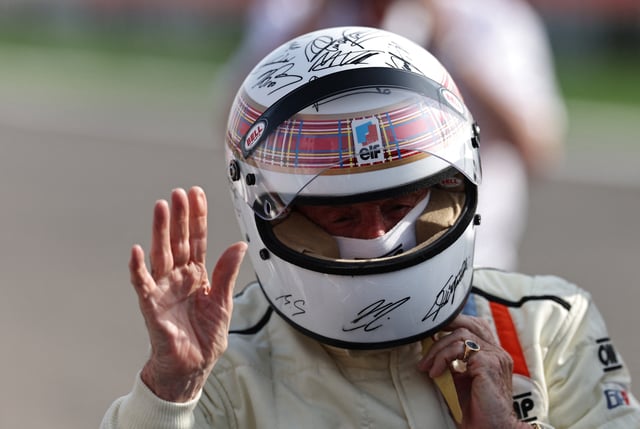 Formula One F1 - Bahrain Grand Prix - Bahrain International Circuit, Sakhir, Bahrain - April 13, 2025 Jackie Stewart is pictured wearing a helmet to be auctioned off to raise funds for Sir Jackie Stewart's Race Against Dementia charity after driving his 1973 title-winning Tyrrell ahead of the Bahrain Grand Prix REUTERS/Hamad I Mohammed