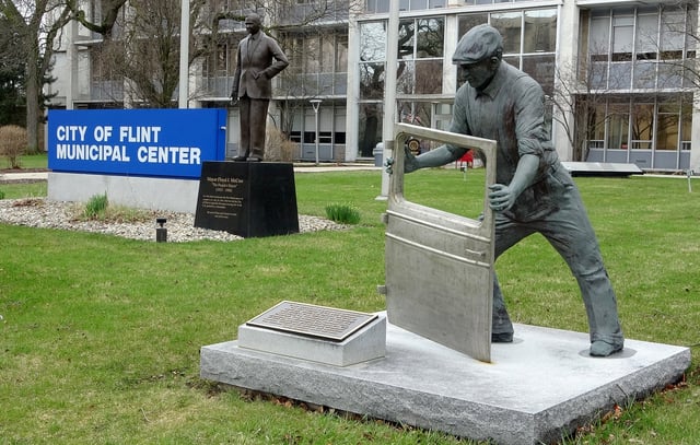 A sculpture of an autoworker with a vehicle door is seen in front of the Flint, Mich., municipal centre, Saturday, April 5, 2025. There are reminders of the story of the American automobile industry on street corners around the Michigan city. THE CANADIAN PRESS/Kelly Geraldine Malone
