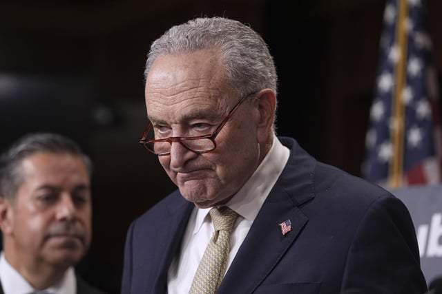 Senate Minority Leader Chuck Schumer, D-N.Y., joined at left by Sen. Ben Ray Lujan, D-N.M., speaks to reporters before the start of a voting marathon as Senate Republicans push the next step to pass President Donald Trump's budget agenda, at the Capitol, in Washington, Friday, April 4, 2025. (AP Photo/J. Scott Applewhite)