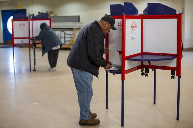 Voters mark their ballots at a polling station on the Navajo Nation in Fort Defiance, Ariz., on Election Day, Tuesday, Nov. 5, 2024.